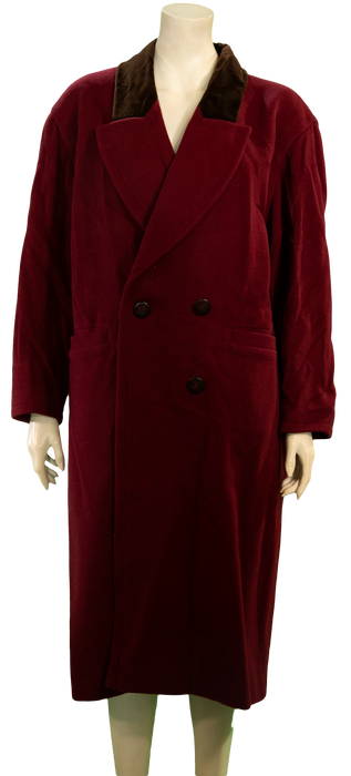 Mannequin wearing a long red velvet double-breasted coat with black buttons and a dark collar.