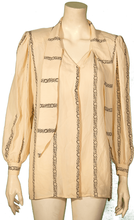 Beige vintage blouse with patterned stripes and puff sleeves displayed on a mannequin