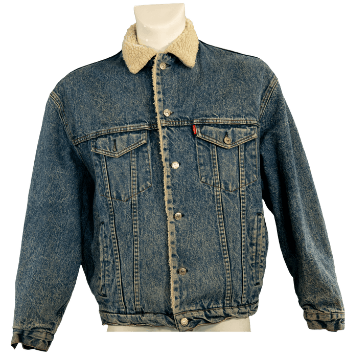 Vintage denim jacket with sherpa lining and button closure in classic blue.