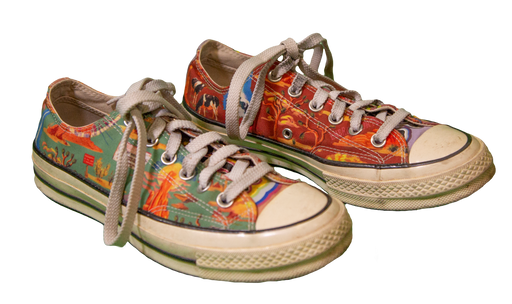 Colorful vintage sneakers with artistic designs and white laces.