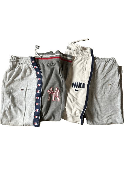 Vintage wholesale branded cotton trousers mix from the 70s-00s includes Champion, NY Yankees, and Nike, offering premium vintage fashion.