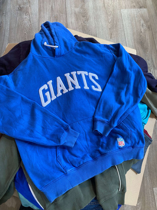 Blue Giants hoodie sweatshirt with white logo displayed on a wooden floor background.