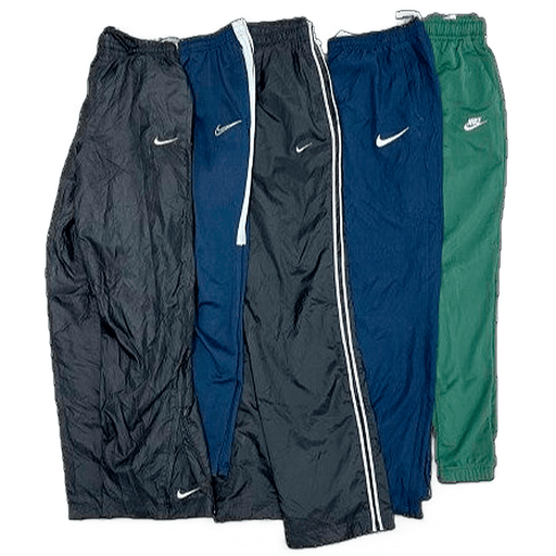 Vintage wholesale Nike trackpants from the 70s to 00s in various colors, showcasing classic sports fashion.