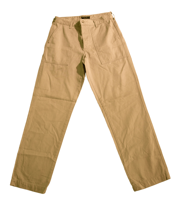 Beige khaki pants with front pockets and belt loops displayed on a green background.