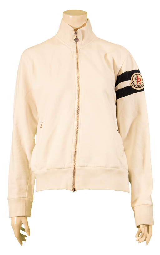 Cream-colored zip-up jacket with high collar and insignia on the sleeve