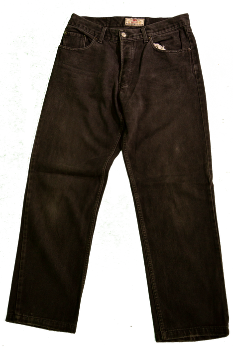 Black denim jeans displayed on green background with front pockets and belt loops.