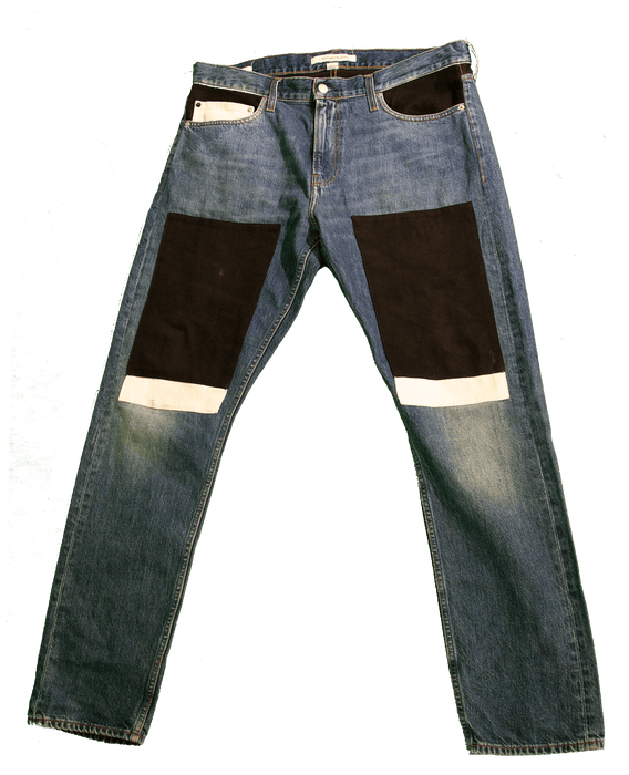 Stylish denim jeans with unique black and white patches on the thighs and knees, offering a fashionable and trendy look