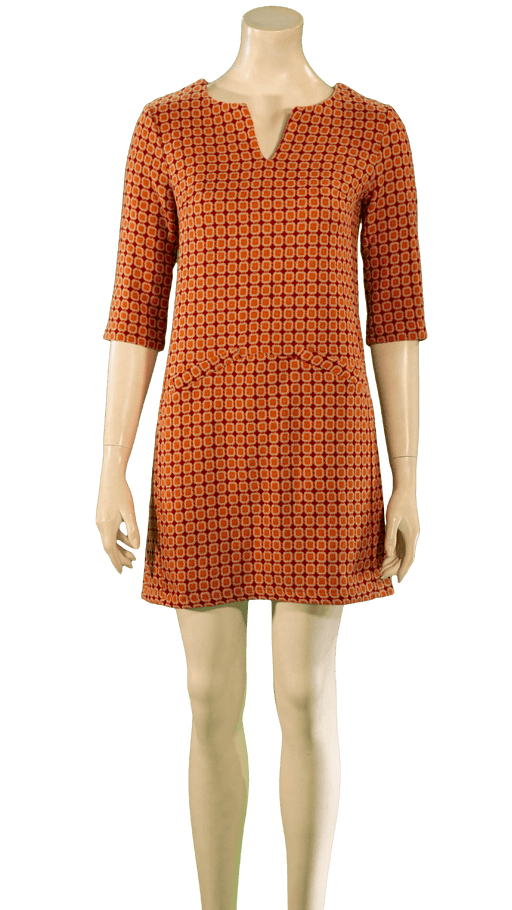 Orange patterned dress with three-quarter sleeves and a short hemline displayed on a mannequin.