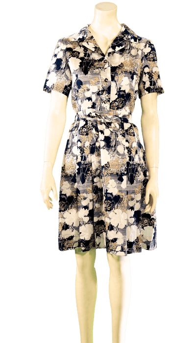 Floral print shirt dress with short sleeves and belted waist on mannequin