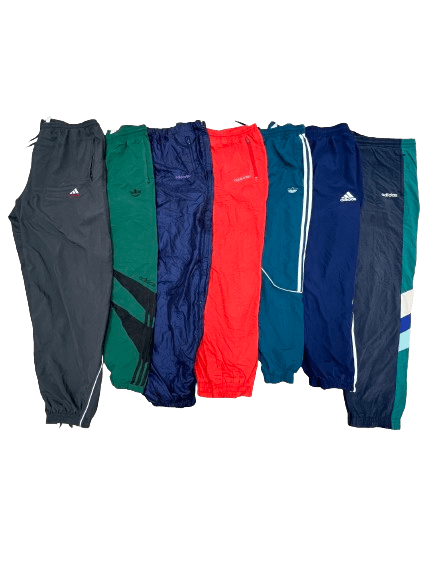 Vintage Wholesale mix of Adidas parachute pants from the 70s to 00s in various colors, perfect for retro fashion enthusiasts.