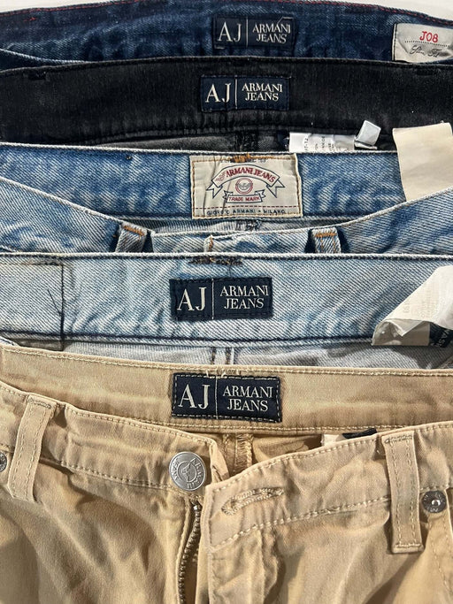 Assorted vintage Armani jeans from the 70s to 00s in different colors and styles, featuring Armani Jeans labels.