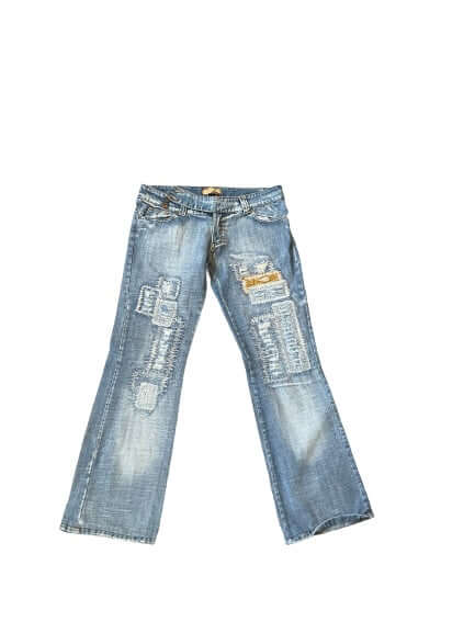 Vintage distressed blue jeans with patchwork and flare legs. Fashionable denim for casual style.