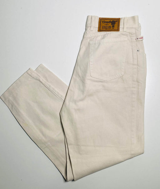 White denim jeans with leather brand tag, folded and displayed on a white background