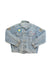 Vintage blue denim jacket with unique patches on the sleeves and chest laying flat.