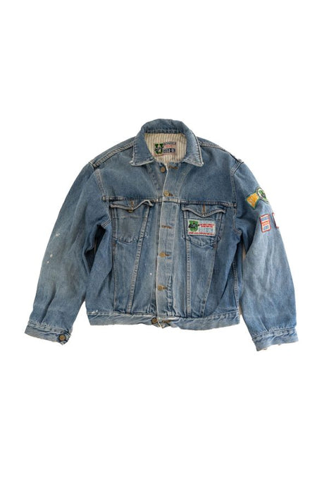 Vintage blue denim jacket with unique patches on sleeves and front pockets. Perfect blend of style and comfort for casual wear.