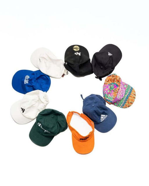 A collection of colorful branded baseball caps arranged in a circle on a white background.